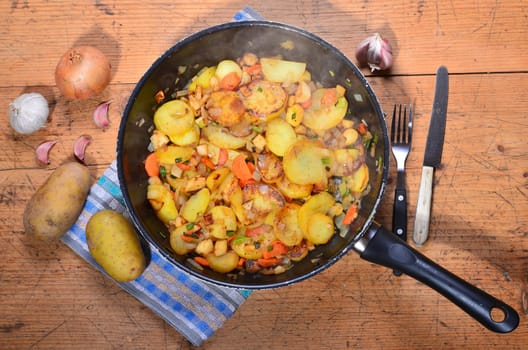 Roast potatoes in a black pan