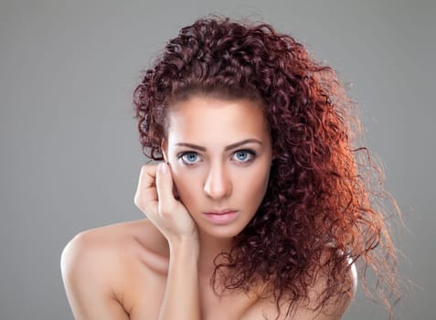 Beautiful young woman with red curly hair