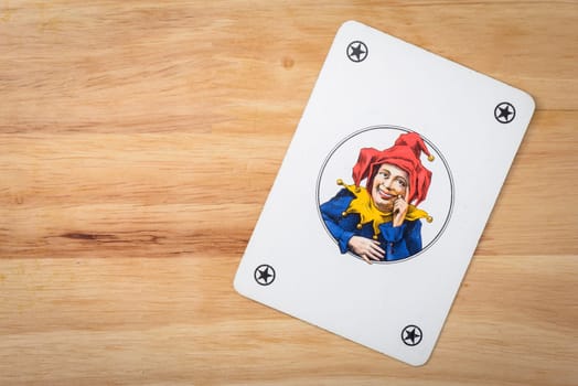 Jocker card on a wood background
