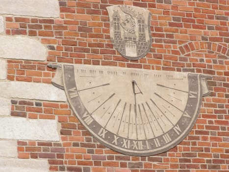 Ancient sundial on a building wall in Krakow