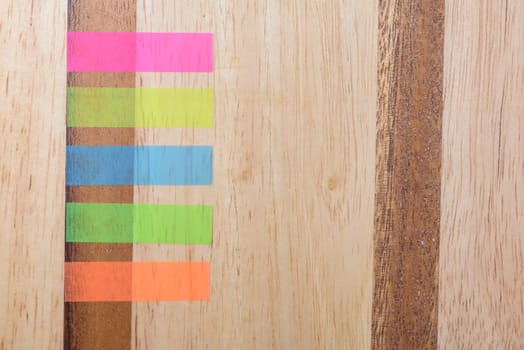 Notes five colours horizontal on wood background