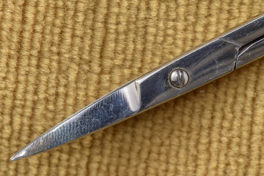 Scissor tips on a brown texile background