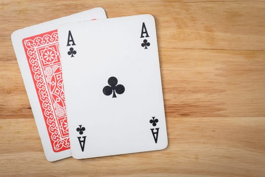 Ace and cover card on a wood background