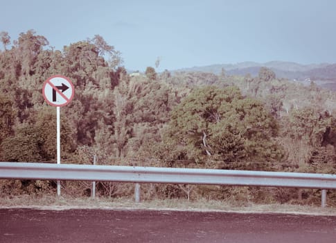 Right-turn prohibition sign with mountain background in vintage effect