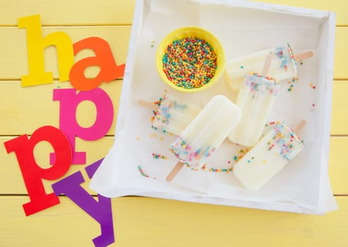 Homemade vanilla ice cream on the stem with colorful sprinkles