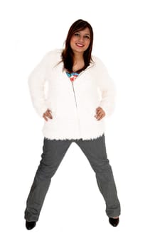 A brunette young woman standing isolated for white background wearing.a short white jacket an high heels..