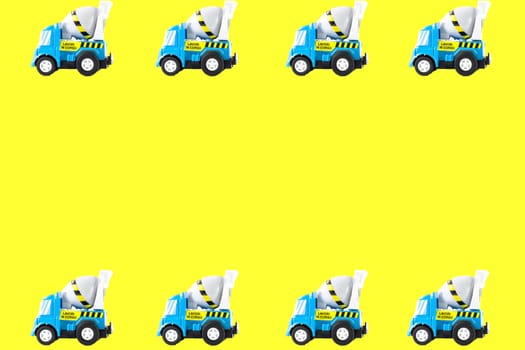Frame of Toy cars. Concrete mixer Toys Truck. yellow background