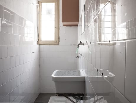bathroom of a cell. .sink and toilet squat.