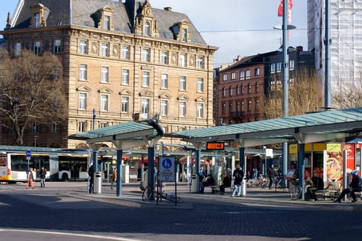 Mainz,Germany – March 31,2015: The central bus stop in Mainz in front of the main train station with pedestrians and waiting people on March 31,2015 in Mainz.