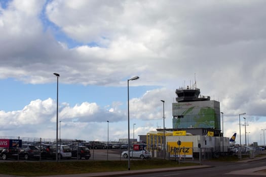 Hahn,Germany – March 31,2015: The car rentals of Hertz and Avis in front of the Airport Tower of Frankfurt Hahn Airport on March 31,2015 in Hahn.