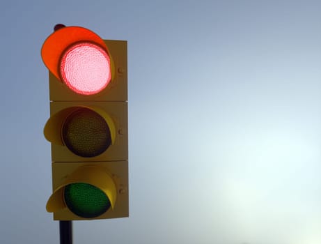 Outdoor vertical traffic light. Traffic control concept image with shallow depth of field.