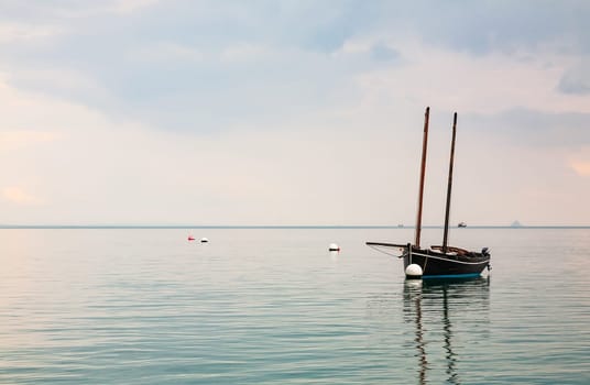 Boat reflecting in calm sea in Cancale, Brittany, France