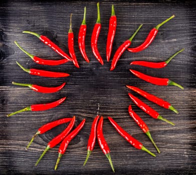 The top view of spicy red chili pepper on wooden surface. Selective focus