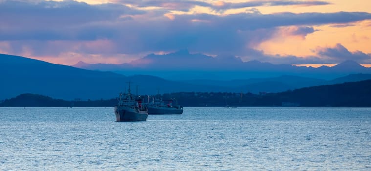 The fishing ships at sunset in the Avacha Bay on the Kamchatka Peninsula