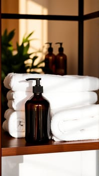Spa treatment set, wooden shelf with neatly folded towels and dispensers for soap, cream, massage oil. High quality photo