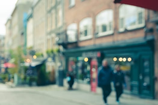 Blurred abstract street view of old town buildings and shopping stores with bokeh lights background