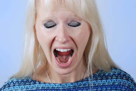Young blonde woman with a cry