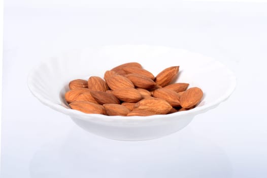 Almonds in a bowl isolated on a white background