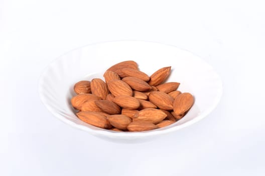 Almonds in a bowl isolated on a white background