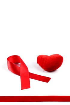 Aids ribbon and heart on white background.