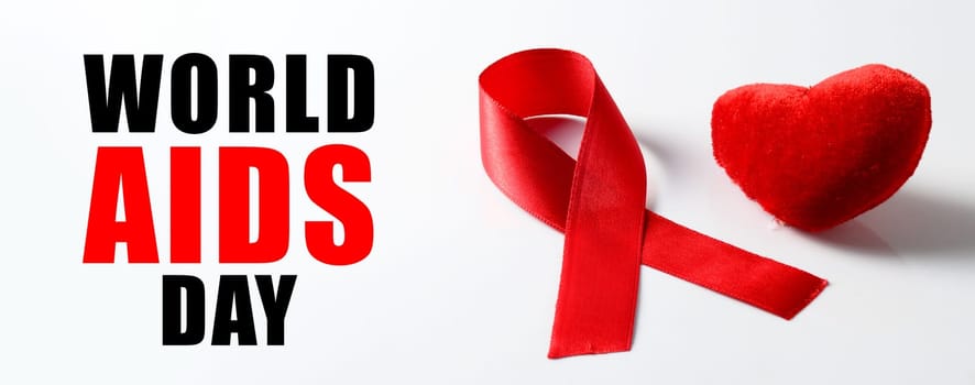 Aids ribbon and heart on white background.