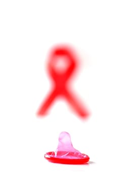 Aids ribbon and condom on white background.