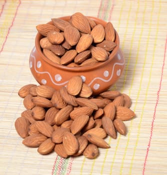 Almonds in a clay pot isolated on a white background