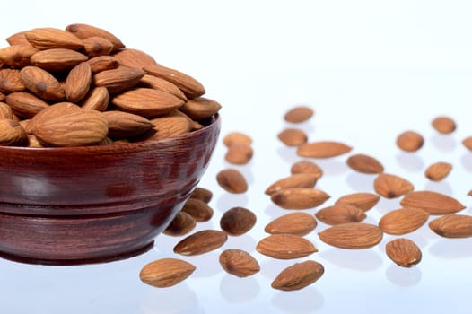 Almonds in a clay pot isolated on a white background
