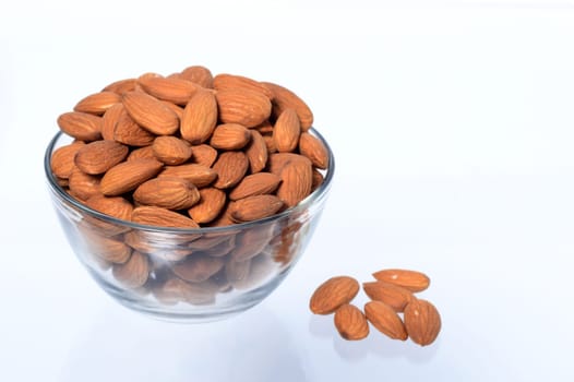 Almonds in a bowl isolated on a white background