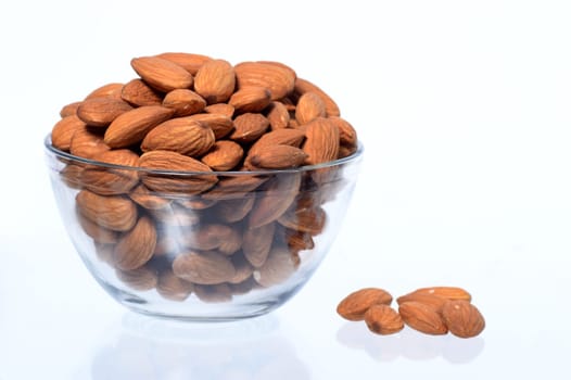Almonds in a bowl isolated on a white background