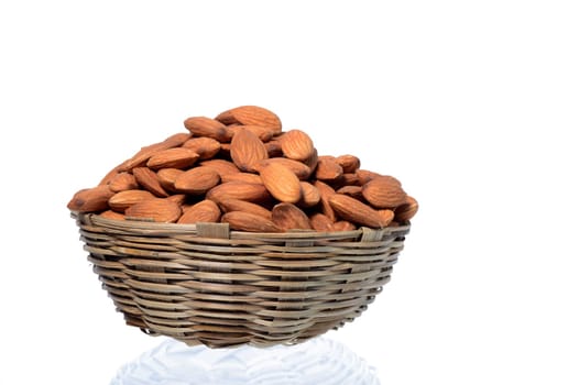 Almonds in a wooden basket with heap isolated on a white background