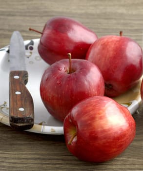 Ripe red apples on wooden background