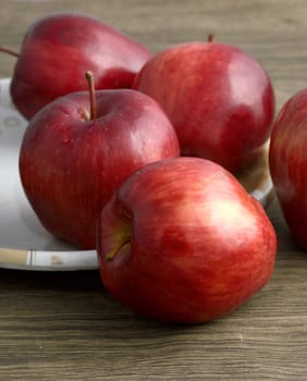 Ripe red apples on wooden background