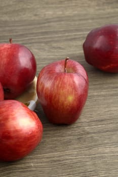 Ripe red apples on wooden background