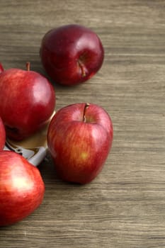 Ripe red apples on wooden background
