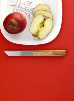 Ripe Red Apples on red background