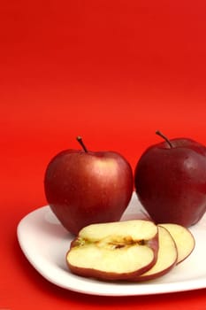 Ripe Red Apples on red background