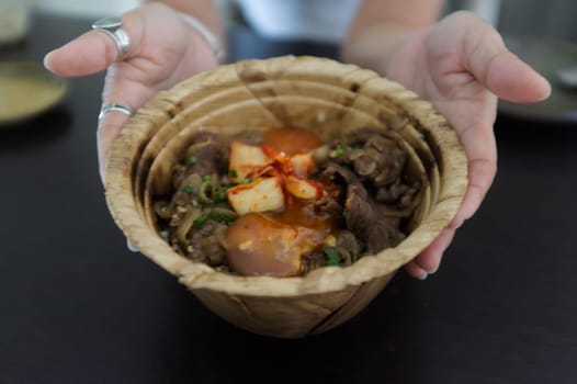 Japanese Gyudon with egg or Japanese beef bowl with egg in organic banan leaf bowl