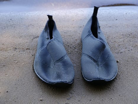 swimming slippers on the sand close-up