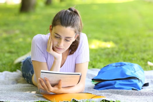 Student studying reading notes in a campus