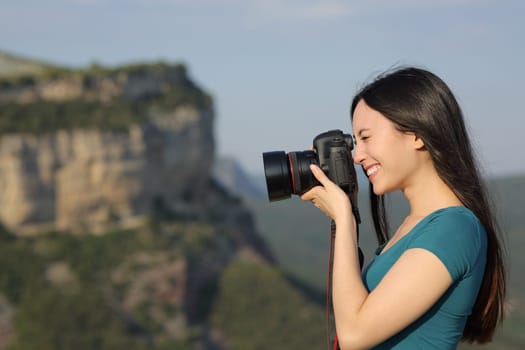 Asian woman taking photos with a dslr camera outdoors