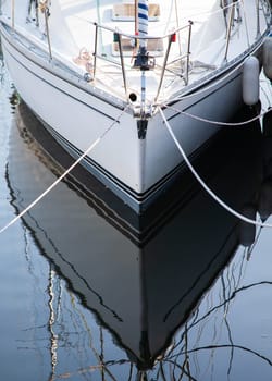 Boat hull at the port reflecting symmetrical in the water