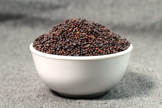 Brown Mustard Seeds in bowl on sackcloth