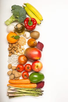 Healthy food clean eating selection: fruit, vegetable, seeds, superfood, cereals, leaf vegetable on white with copy space. Diet concept. Flat lay, top view
