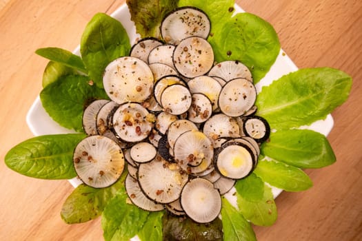 Black radish salad with spices in a plate