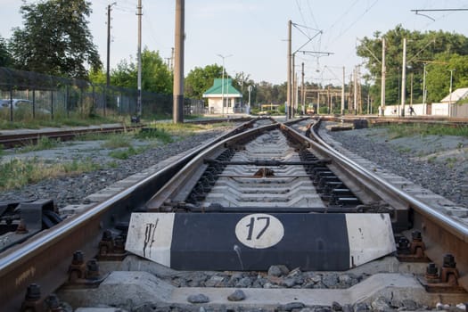 Abstract view of railway arrows. A turnout switch for rails in railway traffic. Rails, sleepers and crushed stone on the railway track. Switching transitions