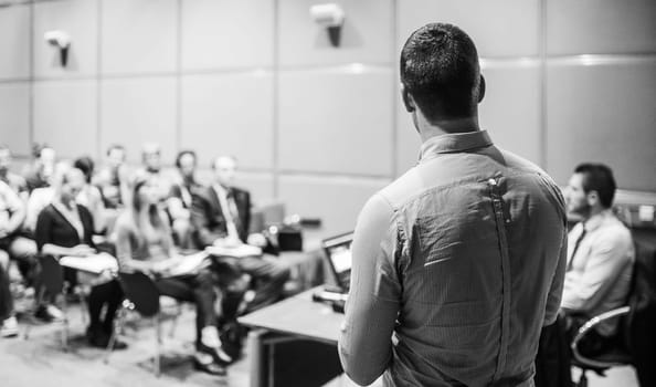 Speaker at Business Conference with Public Presentations. Audience at the conference hall. Entrepreneurship club. Rear view. Horisontal composition. Background blur.