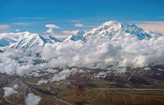 Aerial View of Dramatic Peaks Looming Out of the Clouds of Denali and the Alaska Range in Alaska