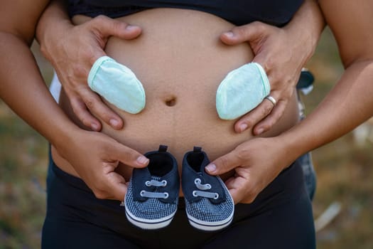 Photos of a pair of shoes and stockings on a pregnant belly