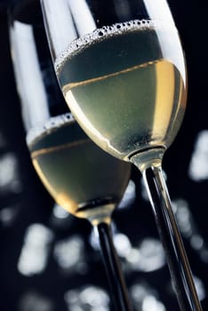 two glasses of champaigne in font of the night lights